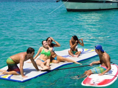 Friends on boogie boards & mats enjoying the water