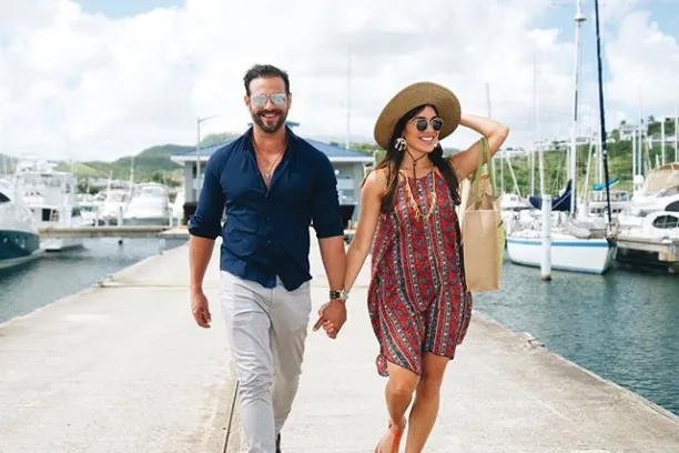 a man standing next to a body of water