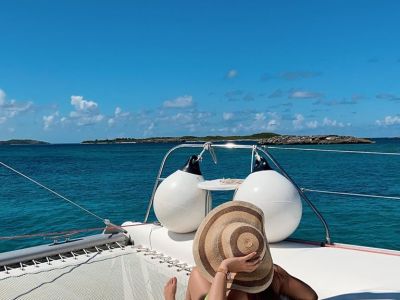 a blue and white boat sitting next to a body of water