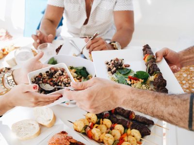 a woman sitting at a table with a plate of food