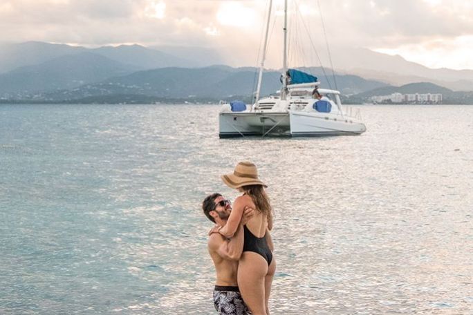 a person standing next to a body of water